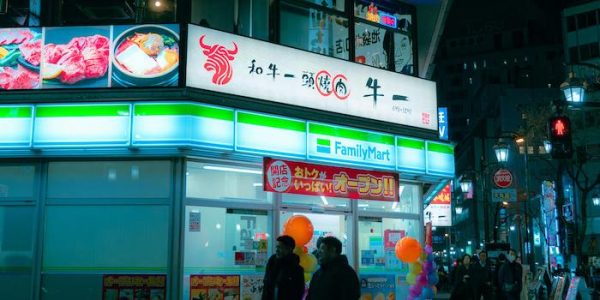 A vibrant Chinese street scene featuring a FamilyMart convenience store with neon signage at night
