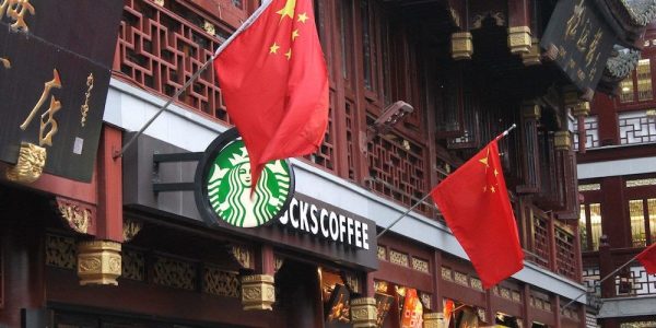 A Starbucks in China, with two Chinese flags hanging out front